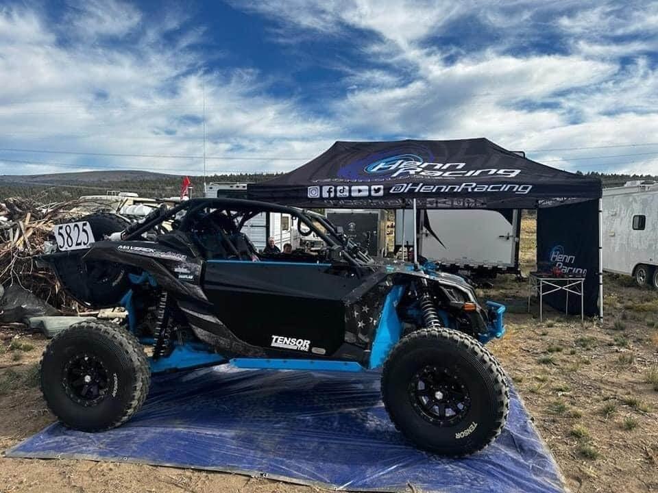 Custom Henn Racing tent and side-by-side at an outdoor riding event